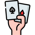 Χέρι που κρατά δύο φύλλα τράπουλας με άσσο μπαστούνι και άσσο καρό